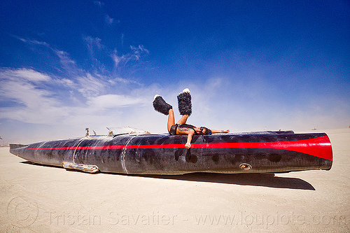 burning man - rocket car by david best, art car, black leg warmers, burning man art cars, furry leg warmers, long, mutant vehicles, rocket car, woman