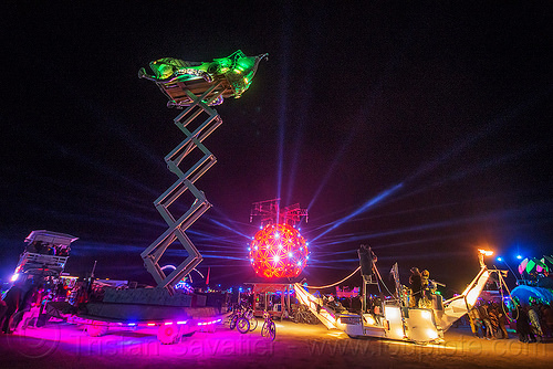 burning man - scissor lift art car at night, boat, burning man art cars, burning man at night, cherrypicker, crescent, elevator, fly me to the moon art car, glowing, mutant vehicles, scissor lift, ship, the ball, unidentified art car