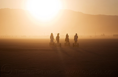 burning man - segways, backlight, haze, hazy, segway x2, segways, silhouettes