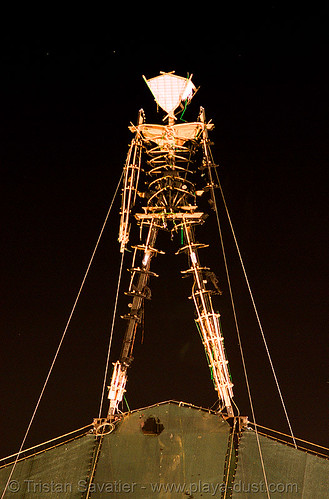 burning man set on fire early due to arson, burned, burning man at night, burnt, charred man, early burn, first burn, first man, man burns early, night of the burn, singed, the man