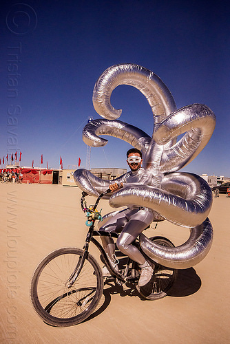 burning man - shiny inflatable costume with tentacles, attire, beard, bicycle, bike, burning man outfit, inflatable art, inflatable costume, mask, masked, riding, shiny, tentacles