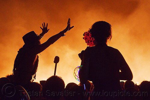 burning man - silhouettes around the man's fire, backlight, burning man at night, celebrating, crowd, dancing, el-wire, fire, glowing, night of the burn, silhouettes