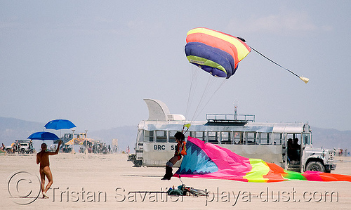 burning man - skydiver landing on the playa - umbrellas - u-man, burning sky, eel, flare, julie wentz, landing, parachute, parachutist, skydiver, skydiving, touch down, u-man, umbrella man