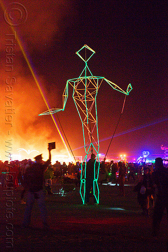 burning man - stick figure walking, art installation, attire, burning man at night, burning man outfit, costume, glowing, the man, walking