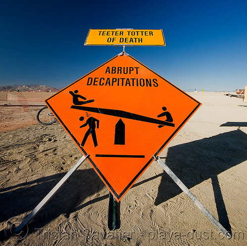 burning man - teeter totter of death - abrupt decapitations, abrupt, beheaded, beheading, decapitations, safety sign, seesaw, stick figures, teeter totter of death, teeter-totter, trick nichols, ttod