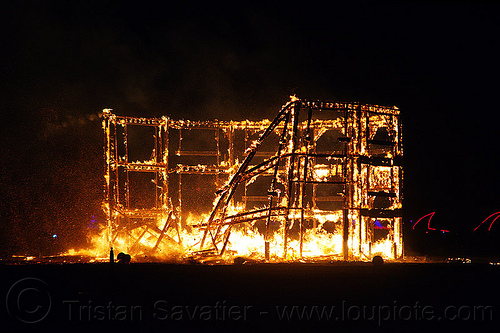 burning man - the burning frame unrolls and collapses, backlight, building, burning man at night, collapsing, fire, night of the burn, silhouettes, the man, wood frame, wooden frame