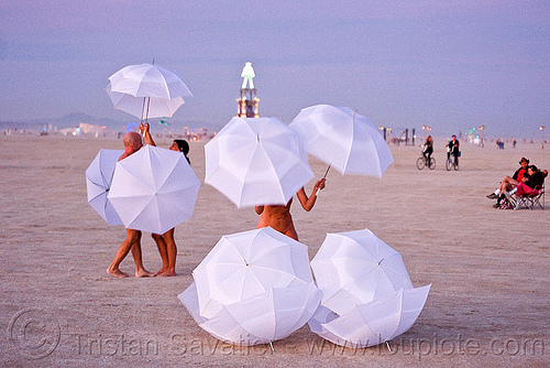 burning man - the umbrella-man performing at dawn, dawn, performance, the man, u-man, umbrella man, white umbrellas