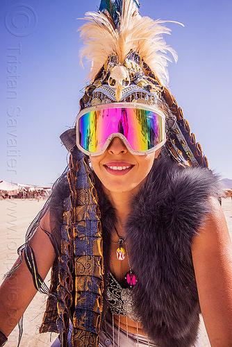 burning man - woman with tribal feather headdress and mirror goggles, attire, bird skull, burning man outfit, costume, fashion, feather headdress, feathers, mirror goggles, rainbow colors, tribal, woman