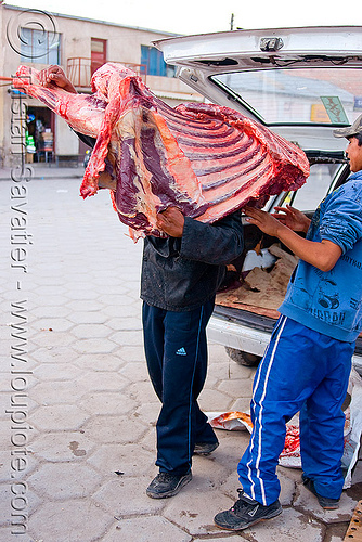 butcher carrying a quarter of beef - uyuni (bolivia), beef, bolivia, butcher, delivery, man, meat market, meat shop, uyuni