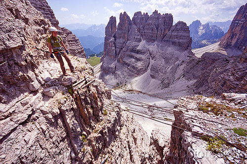 cable foot bridge - monte paterno via ferrata, alps, cables, chasm, cliffs, climber, climbing harness, climbing helmet, dolomites, footbridge, monte paterno, mountain climbing, mountaineer, mountaineering, mountains, parco naturale dolomiti di sesto, rock climbing, shaky bridge, via ferrata, woman