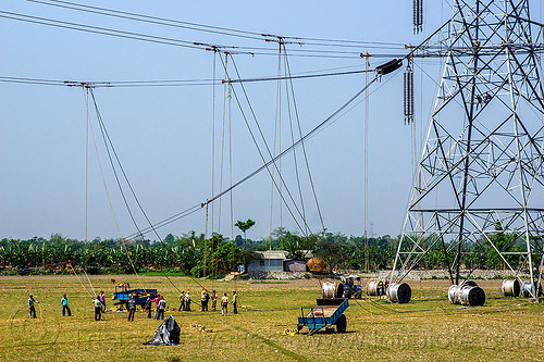 cable riggers installing power lines on transmission tower (india), cable riggers, cable wheels, cables, construction, electric line, electricity pylon, high voltage, men, power transmission lines, pulleys, rigging, ropes, wires, workers