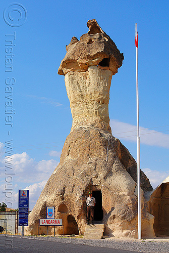 cappadocia fairy chimney - police station in a hoodoo - jandarma (turkey country), architecture, cappadocia, cave dwellings, caves, cop, erosion, fairy chimney, flag pole, geology, göreme, hoodoo, jandarma, law enforcement, man, police post, police station, road, rock formations, rock house, signs, tent rock, troglodyte, turkish police, uniform, volcanic tuff