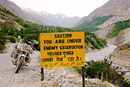 caution you are under enemy observation - sign - leh to srinagar road - kashmir, 500cc, bro road signs, danger, enemy, india, kashmir, motorcycle, river, road sign, royal enfield bullet, valley