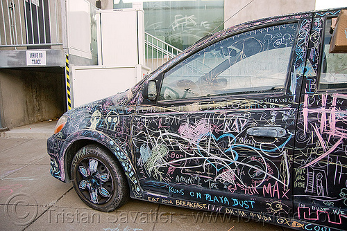chalk writing on car - burning man decompression, black car, chalk writing, graffiti, vandalism