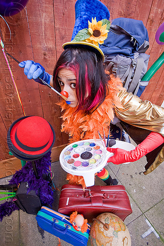 clown act - mumu circus performer, blue lipstick, bowler hat, circus artist, clown hat, clown nose, cocktail hat, feather boa, globe, luggage, paint brush, paint palette, party balloons, performer, props, suitcases, woman