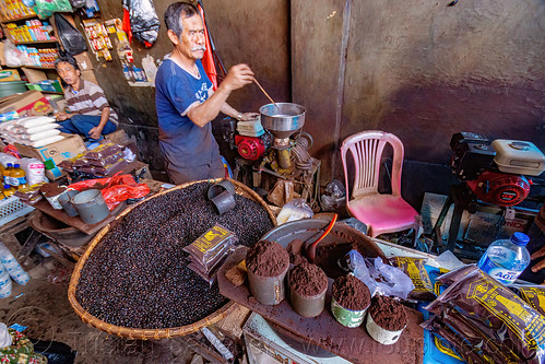 coffee merchant at rantepao market, bolu market, coffee grinder, coffes beans, ground coffee, man, pasar bolu, rantepao, shop, stall, tana toraja