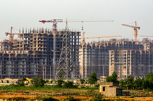 construction of the planned urban development "gaur city 1" in greater noida (india), bamboo scaffoldings, building construction, buildings, construction cranes, electricity pylon, gaur city, greater noida, planned city, transmission tower, urban development, urban planning