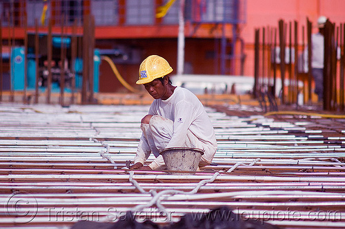 construction worker - deck formwork, borneo, bucket, building construction, concrete forms, concrete wall forms, construction site, construction workers, formwork, malaysia, man, miri, rebars, safety helmet, squating