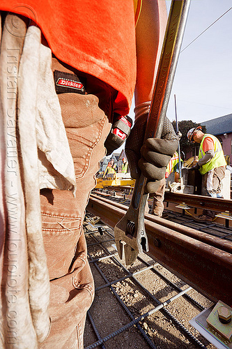 construction worker holding a wrench, construction workers, duboce, hand, light rail, men, muni, ntk, railroad construction, railroad tracks, railway tracks, san francisco municipal railway, track maintenance, track work, workshop rag, wrench