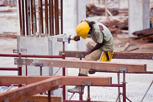 construction worker - shoring, borneo, building construction, construction site, construction workers, hammer, lumber, malaysia, man, miri, rebars, safety helmet, scaffolding, shoring, sitting, timber, working