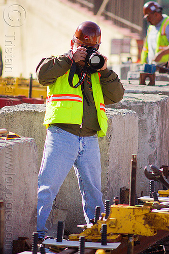 construction worker taking photos, camera, construction worker, duboce, high-visibility jacket, high-visibility vest, light rail, men, muni, ntk, photographer, railroad construction, railroad tracks, railway tracks, reflective jacket, reflective vest, safety helmet, safety vest, san francisco municipal railway, track maintenance, track work, wrench