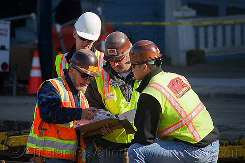 construction workers checking the project blueprint, blueprint, construction workers, duboce, foreman, foremen, high-visibility jacket, high-visibility vest, light rail, men, muni, ntk, railroad construction, railroad tracks, railway tracks, reflective jacket, reflective vest, safety helmet, safety vest, san francisco municipal railway, surveyors, track maintenance, track work, working