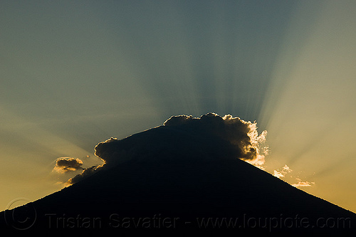 crepuscular rays on gunung agung volcano at sunset, agung volcano, backlight, bali, crepuscular rays, gunung agung, haze, hazy, mountains, silverlining, stratovolcano, sun rays through clouds, sunset