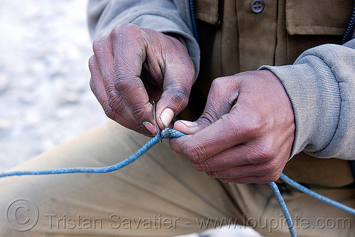 cutting the dynamite fuse - drilling and blasting - near keylong - manali to leh road (india), construction worker, cutting, drilling and blasting, dynamite blasting, fuses, fuzes, groundwork, hands, man, razor blade, road construction, roadworks, working