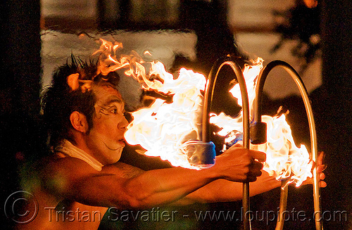 dai zaobab holding s-shaped fire staves - japanese fire performer, dai zaobab, fire dancer, fire dancing expo, fire performer, fire spinning, fire staffs, fire staves, man, night, spinning fire, temple of poi