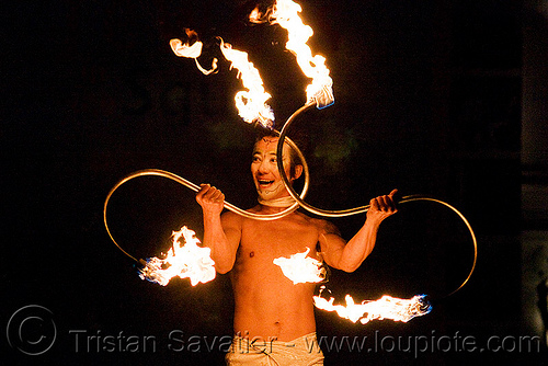 dai zaobab with s-shaped fire staves - japanese fire performer - temple of poi 2009 fire dancing expo - union square (san francisco), dai zaobab, fire dancer, fire dancing expo, fire performer, fire spinning, fire staffs, fire staves, man, night, spinning fire, temple of poi