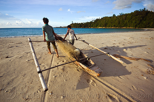 double outrigger fishing canoe on beach, bangka, borneo, boy, double outrigger canoe, fisherman, fishermen, fishing canoe, fishing net, kelambu beach, malaysia, man, ocean, sand, sea, seashore, small boat