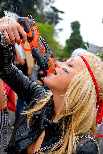 drinking from a water gun, bay to breakers, blonde, costume, drinking, footrace, head band, squirt gun, street party, toy gun, water gun, water pistol, woman