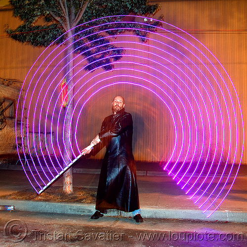 duane with led-light saber - superhero street fair (san francisco), concentric circles, duane, islais creek promenade, led-light saber, man, night, shiftbrite, superhero street fair