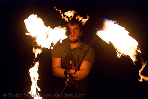 eric spinning fire staffs (san francisco), double staff, fire dancer, fire dancing, fire performer, fire spinning, fire staffs, fire staves, night, spinning fire