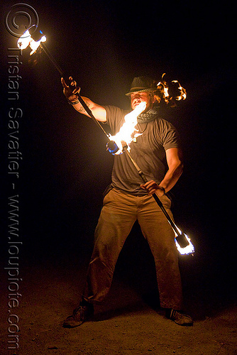 eric spinning fire staffs (san francisco), double staff, fire dancer, fire dancing, fire performer, fire spinning, fire staffs, fire staves, night, spinning fire