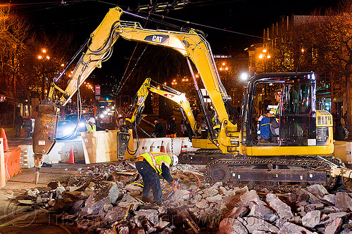 excavators with jackhammer attachments, at work, attachment, demolition, excavators, high-visibility jacket, high-visibility vest, hydraulic jackhammer, light rail, man, muni, ntk, railroad construction, railroad tracks, railway tracks, reflective jacket, reflective vest, safety helmet, safety vest, san francisco municipal railway, track maintenance, track work, worker, working