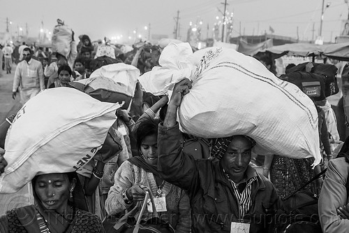 exodus of hindu pilgrims with luggage in bags over head - kumbh mela (india), bags, bundles, carrying on the head, exodus, hindu pilgrimage, hinduism, india, luggage, maha kumbh mela, men, night, walking, women