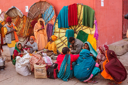 family of hindu pilgrims on the ghats of varanasi (india), colorful, family, ghats, hindu, hinduism, indian women, men, sitting, squatting, varanasi