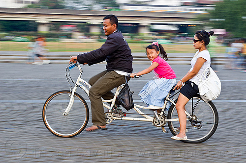 family riding tandem2 - family on tandem, child, family, jakarta, kid, little girl, man, medan merdeka, merdeka square, moving, park, riding, road, tandem bicycle, tandem bike, woman