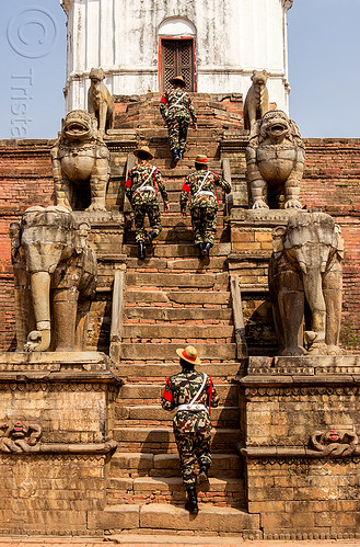 fasidega temple - nepali gurkha army soldiers walking up steps - bhaktapur durbar square (nepal), bhaktapur, durbar square, elephants, fatigues, gorkhas, guards, gurkha army, gurkha regiment, gurkhas, hat, hindu temple, hinduism, men, military, nepalese army, red stripe, sculptures, soldiers, stairs, statues, steps, stone elephant, stone lions, uniform, walking