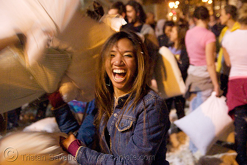 feisty girl at the great san francisco pillow fight 2008, down feathers, night, pillows, world pillow fight day