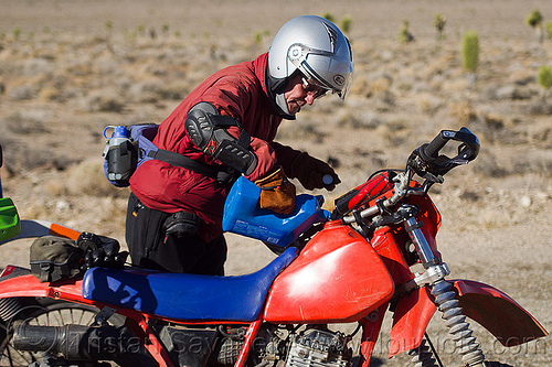 filling the tank of the dirt motorbike, death valley, filling-up, fuel, gas tank, gasoline, honda, jerrycan, man, motorcycle helmet, motorcycle touring, mototbike, petrol, plastic can, pouring, xr 350