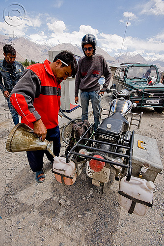 filling-up the jerrycans at the diskit petrol station - nubra valley - ladakh (india), diskit, filling-up, fuel, gas pump, gas station, gasoline, jerrycans, ladakh, manuel, motorcycle touring, nubra valley, petrol pump, petrol station, pouring, road, royal enfield bullet