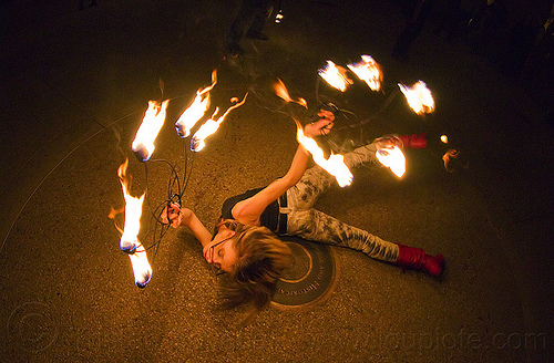 fire dancer laying on the ground with fire fans - cressie mae, cressie mae, fire dancer, fire dancing, fire fans, fire performer, fire spinning, night, woman