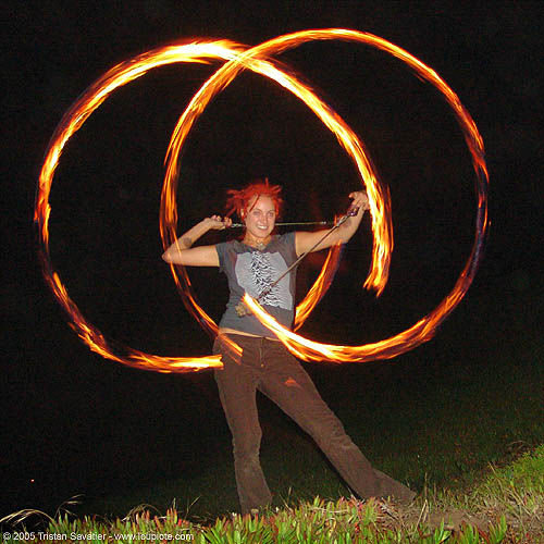fire dancer making two fire circles (san francisco), circles, fire dancer, fire dancing, fire performer, fire poi, fire spinning, night, red hair, redhaired, redhead, ring, spinning fire, woman