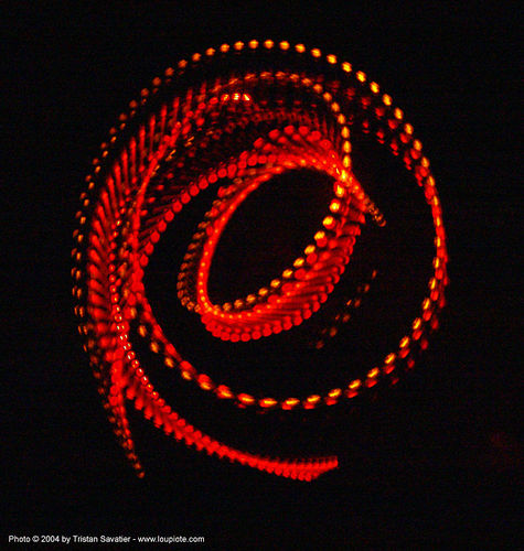 fire-dancer-using-lightsticks - rainbow gathering - hippie, fire dancer, fire dancing, fire performer, fire poi, fire spinning, hippie, led lights, night, spinning fire