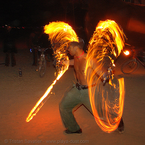 fire dancer with fire swords - burning man 2006, burning man at night, celsius maximus, fire dancer, fire dancing, fire performer, fire spinning, fire swords, spinning fire