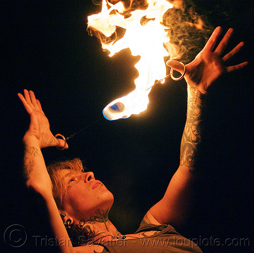 fire performer with fire doohickey, fire dancer, fire dancing, fire doohickey, fire performer, fire spinning, handa, leah, night, tattooed, tattoos, woman