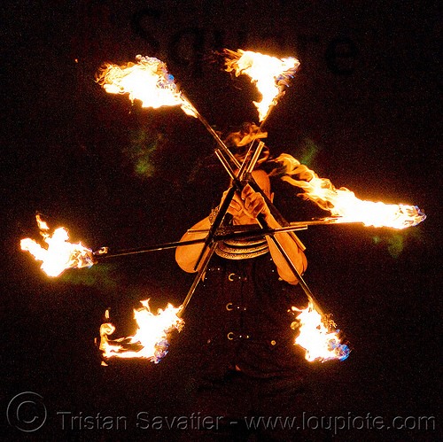 fire performer with staffs - "manda lights" - temple of poi 2009 fire dancing expo - union square (san francisco), fire dancer, fire dancing expo, fire performer, fire spinning, fire staffs, fire staves, man, manda lights, night, spinning fire, surya, sûrya, temple of poi