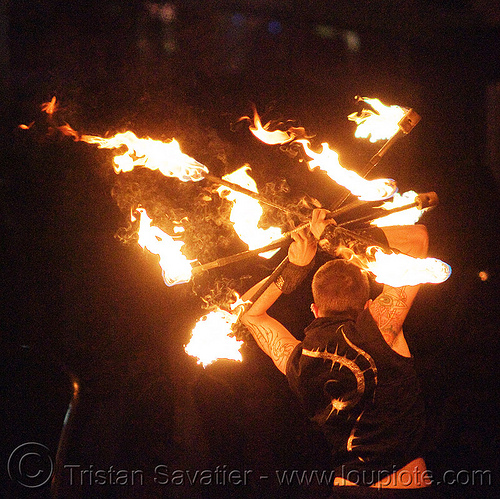 fire staves - performer - temple of poi 2010 fire dancing expo (san francisco), fire dancer, fire dancing expo, fire performer, fire spinning, fire staffs, fire staves, night, temple of poi, union square